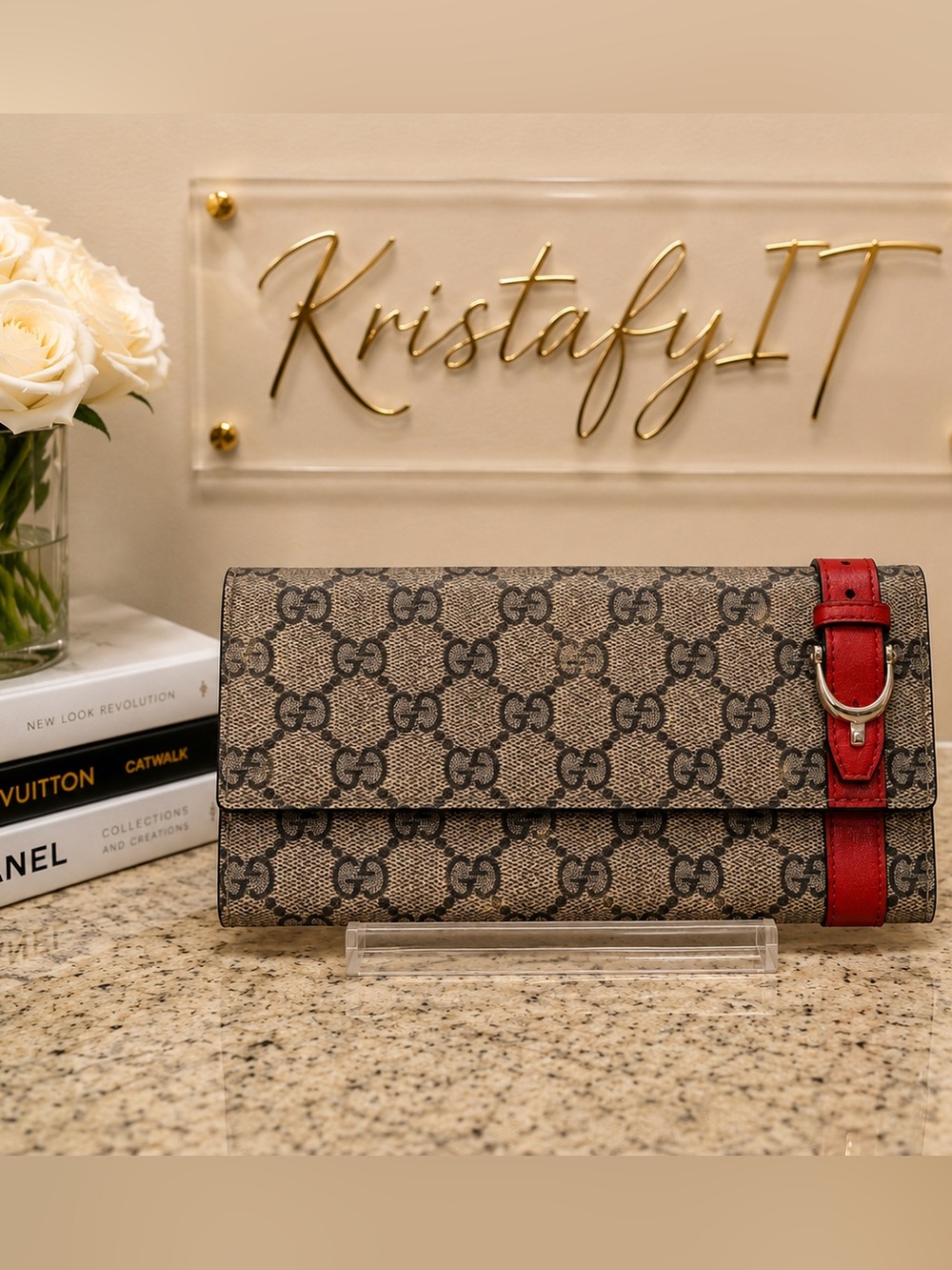 Gucci GG canvas Guccissima wallet with a red leather strap.